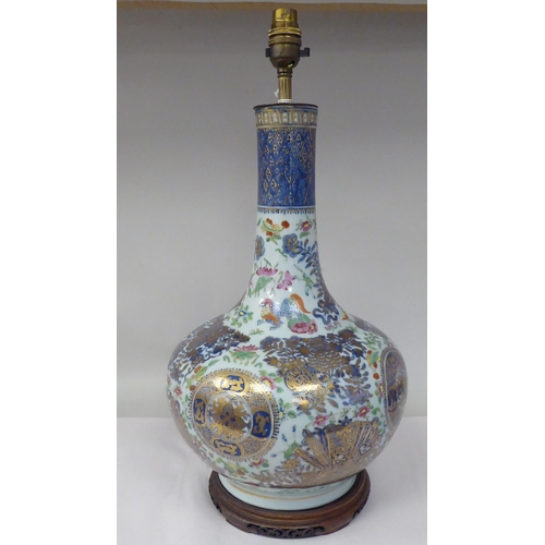 48 - An early 20thC Chinese porcelain bottle vase design table lamp, decorated in colours and gilding wit... 