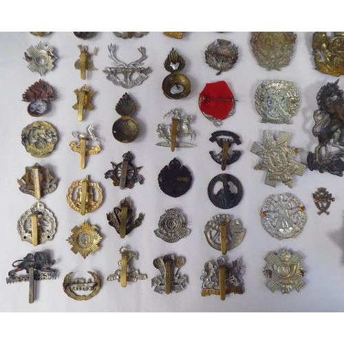 58 - Approx. fifty-five military cap badges and other insignia, some copies: to include Lowland Regiment;... 