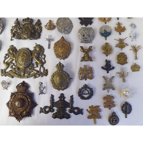 58 - Approx. fifty-five military cap badges and other insignia, some copies: to include Lowland Regiment;... 