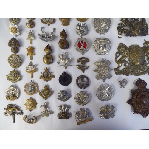 58 - Approx. fifty-five military cap badges and other insignia, some copies: to include Lowland Regiment;... 