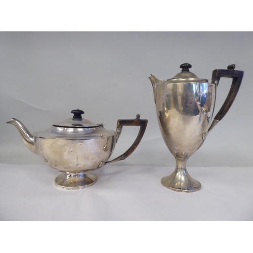 61 - An Edwardian four piece silver tea set of pedestal lamp design, comprising a teapot with a swept spo... 