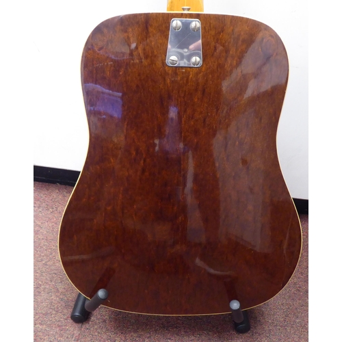 64 - An Eko Italian made, twelve string acoustic guitar with a stand and soft fabric case