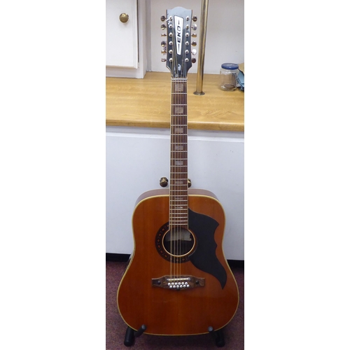 64 - An Eko Italian made, twelve string acoustic guitar with a stand and soft fabric case