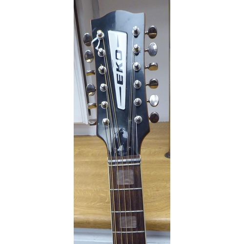 64 - An Eko Italian made, twelve string acoustic guitar with a stand and soft fabric case