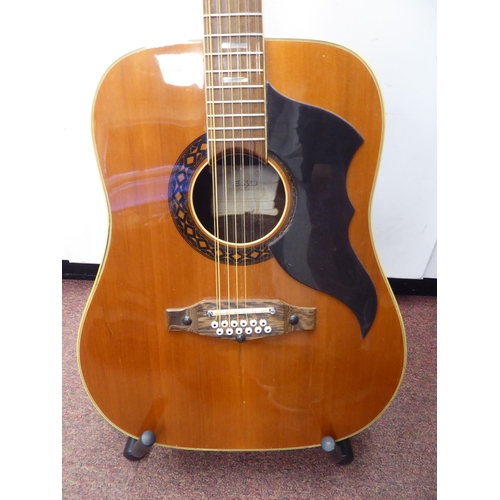 64 - An Eko Italian made, twelve string acoustic guitar with a stand and soft fabric case