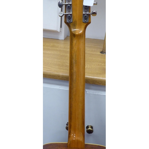 64 - An Eko Italian made, twelve string acoustic guitar with a stand and soft fabric case