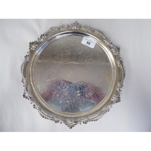 66 - A late Victorian silver salver with a raised, C-scrolled and shell cast border and conforming surfac... 