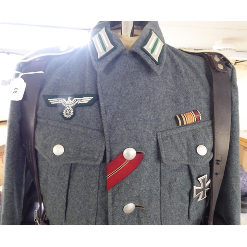 68 - A German World War II design military tunic with emblems and an associated ammunition belt(Please No... 