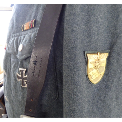 68 - A German World War II design military tunic with emblems and an associated ammunition belt(Please No... 