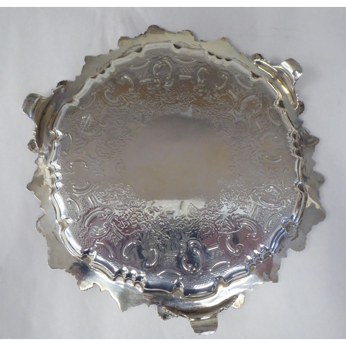 70 - A late Victorian silver salver with a raised, C-scrolled and shell cast border and conforming surfac... 