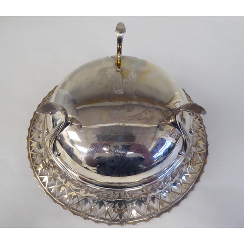 88 - An Edwardian silver basket dish, the shallow bowl with flared and decoratively pierced sides, elevat... 