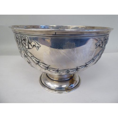 89 - A silver rose bowl with an applied wire rim and embossed ribbon tied garlands, elevated on a domed p... 