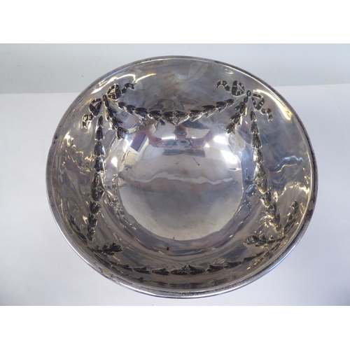 89 - A silver rose bowl with an applied wire rim and embossed ribbon tied garlands, elevated on a domed p... 