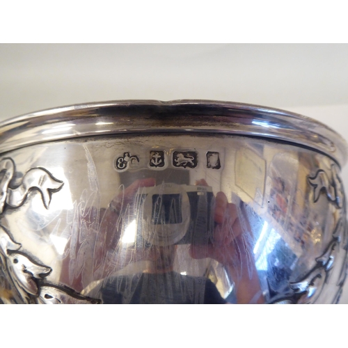 89 - A silver rose bowl with an applied wire rim and embossed ribbon tied garlands, elevated on a domed p... 