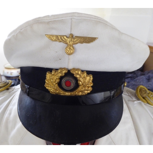 92 - A German World War II style Kreigsmarine tunic with emblems and a peak cap(Please Note: this lot is ... 