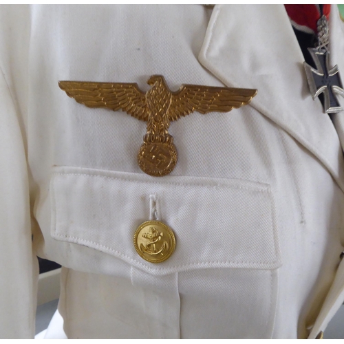 92 - A German World War II style Kreigsmarine tunic with emblems and a peak cap(Please Note: this lot is ... 