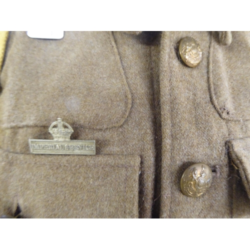 97 - A British Army tunic with webbing belts; and a peaked cap(Please Note: this lot is subject to the st... 