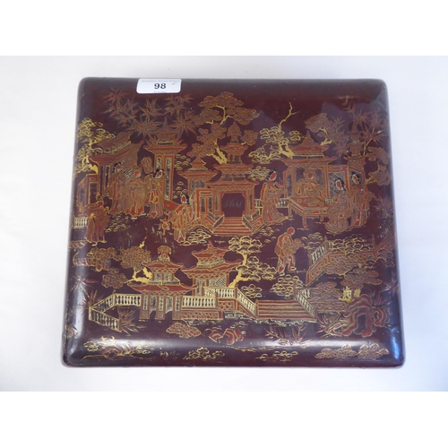 98 - An early 20thC Chinese brown and gilded lacquered wooden table casket, the lid enclosing a series of... 