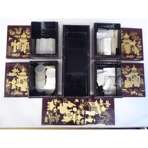 98 - An early 20thC Chinese brown and gilded lacquered wooden table casket, the lid enclosing a series of... 