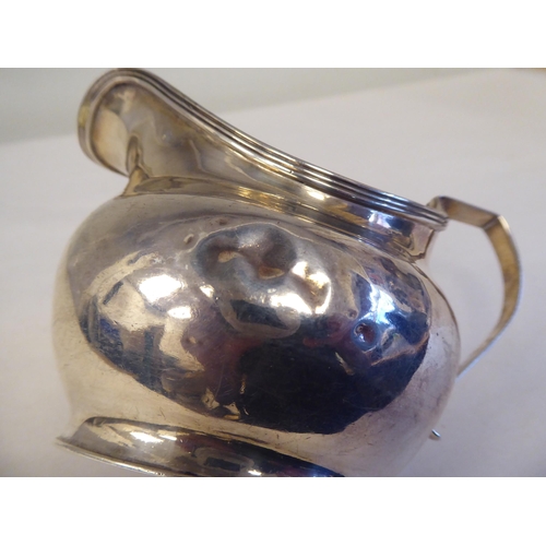 99 - A William IV silver cream jug of oval, bulbous form with an applied wire rim and loop handle  m... 