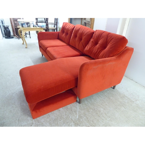 245 - A modern three person settee, upholstered in bright red fabric, raised on pegged feet  82