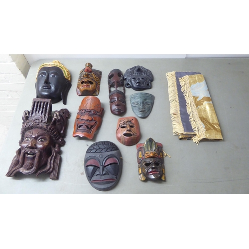 195 - 20thC Asian tourist collectables, mainly wooden masks  largest 11