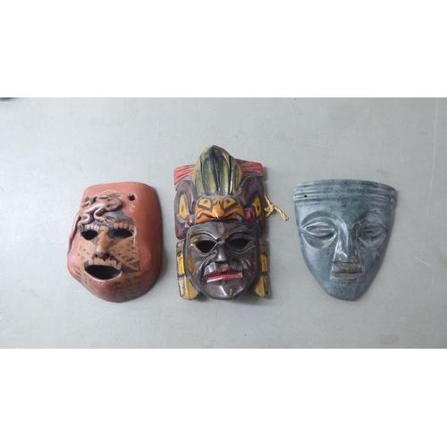 195 - 20thC Asian tourist collectables, mainly wooden masks  largest 11