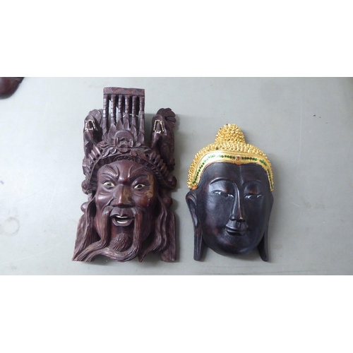 195 - 20thC Asian tourist collectables, mainly wooden masks  largest 11