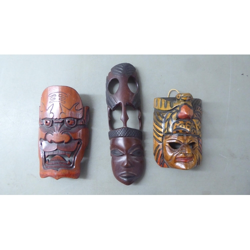 195 - 20thC Asian tourist collectables, mainly wooden masks  largest 11