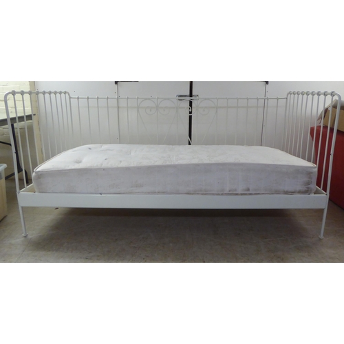 207 - A 20thC white painted tubular and C-scrolled metal framed three side open day bed  77