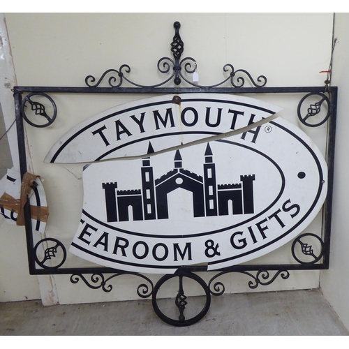 255 - A 20thC cast and wrought black painted metal advertising sign frame  36