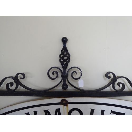 255 - A 20thC cast and wrought black painted metal advertising sign frame  36