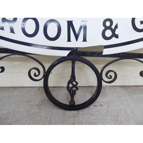 255 - A 20thC cast and wrought black painted metal advertising sign frame  36