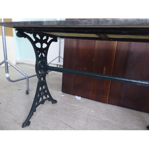 269 - A Victorian style cast iron terrace table base with a drop-in, weathered marble top  28