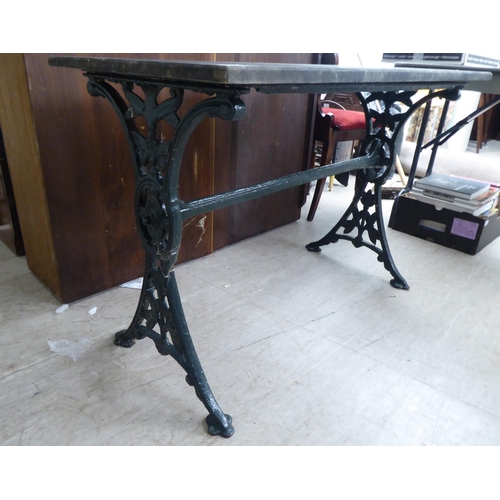 269 - A Victorian style cast iron terrace table base with a drop-in, weathered marble top  28