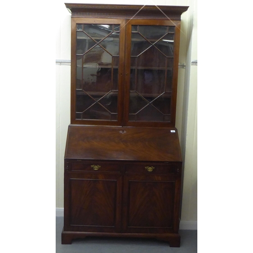 282 - A George III mahogany bureau bookcase with two astragal glazed doors, the fall flap over a drawer an... 