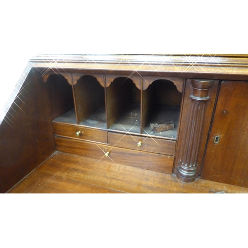 282 - A George III mahogany bureau bookcase with two astragal glazed doors, the fall flap over a drawer an... 