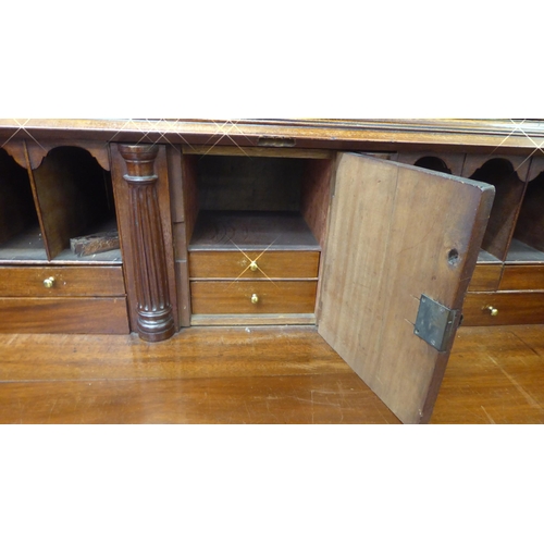 282 - A George III mahogany bureau bookcase with two astragal glazed doors, the fall flap over a drawer an... 