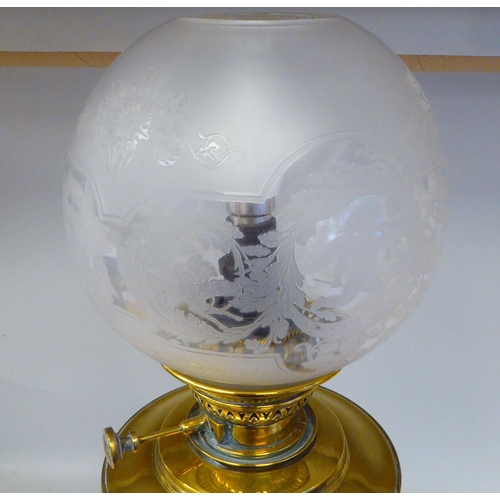 298 - An early 20thC lacquered brass oil lamp (later converted to electricity) with a part-frosted glass b... 