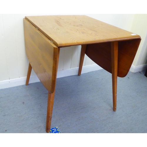 308 - A blonde Ercol elm dining table, raised on square, tapered legs  30