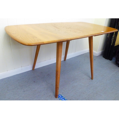 308 - A blonde Ercol elm dining table, raised on square, tapered legs  30