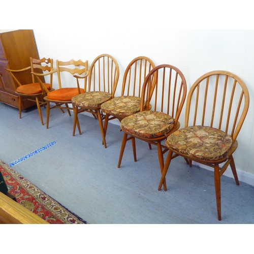 310 - A matched set of six Ercol beech and elm framed dining chairs, comprising four standard/two open arm