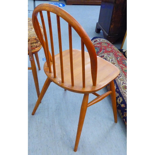 310 - A matched set of six Ercol beech and elm framed dining chairs, comprising four standard/two open arm