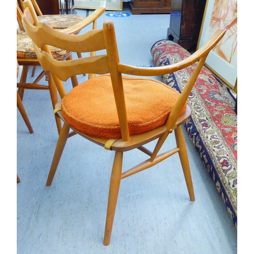 310 - A matched set of six Ercol beech and elm framed dining chairs, comprising four standard/two open arm