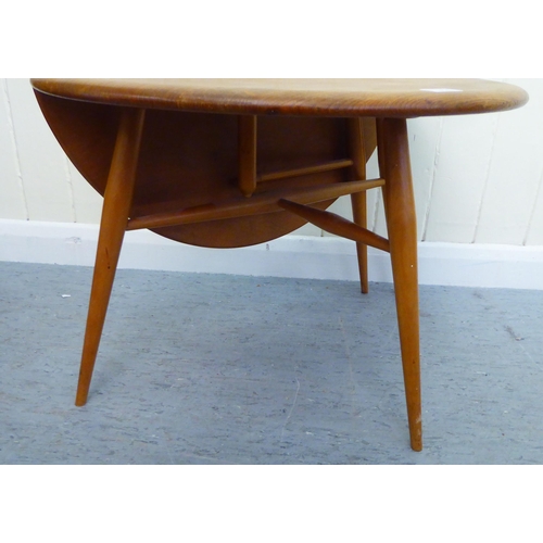 311 - A blonde Ercol elm drop leaf occasional table, raised on turned legs  16