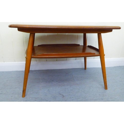 312 - A blonde Ercol elm two tier coffee table, raised on elliptically turned legs  18