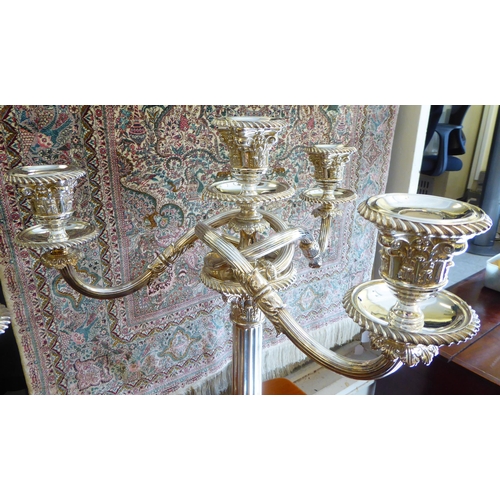 313 - A pair of Edwardian style loaded silver plated Corinthian capital, three branch candelabra, on a ste... 