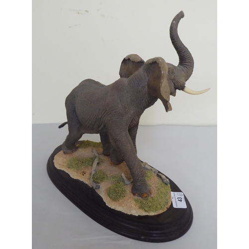 Two similar composition model elephants 12" and 5"h