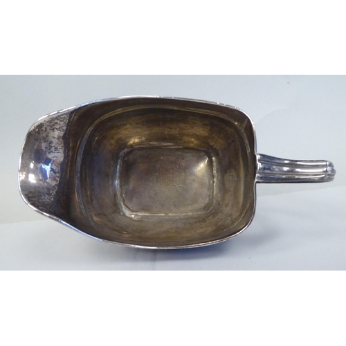 1 - A George III silver oval, ogee shape cream jug with an applied wire rim and loop handle, on ball fee... 