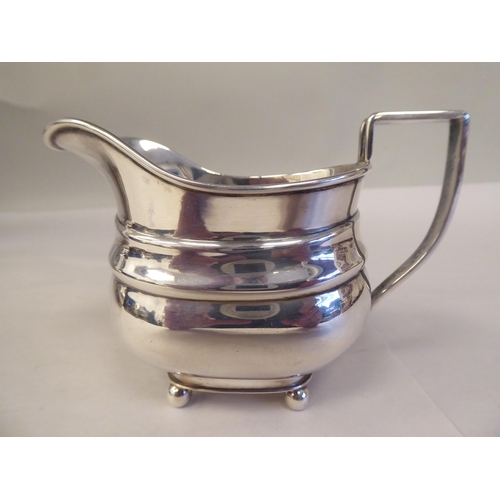 103 - A three piece bachelor's silver tea set of oval ogee form, comprising a teapot with a swept spout, i... 